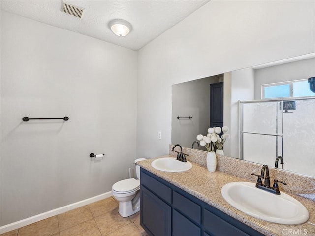 full bath featuring toilet, a stall shower, visible vents, and a sink