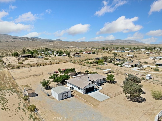 birds eye view of property with view of desert, a rural view, and a mountain view