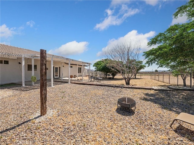 view of yard featuring a patio area, an outdoor fire pit, fence, and a pergola