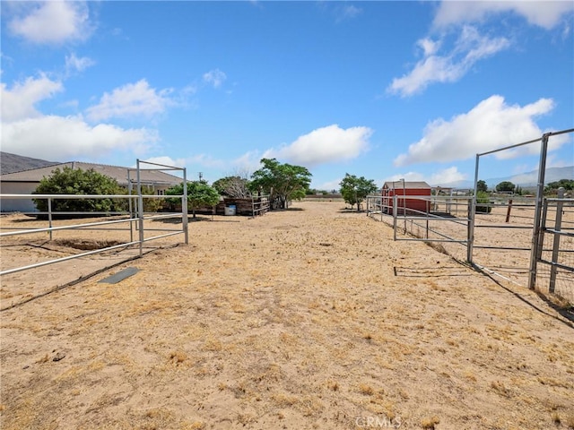 view of yard with an exterior structure, an outdoor structure, and a rural view