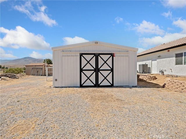 view of shed with a mountain view and central AC unit