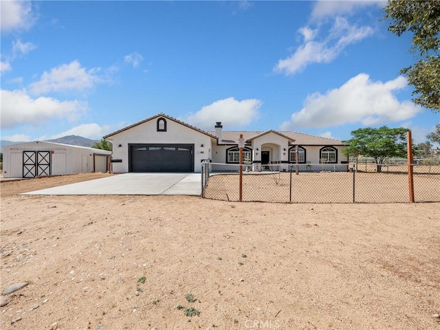 view of front of home with a garage, concrete driveway, a chimney, fence, and stucco siding