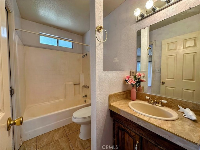 bathroom featuring shower / bathtub combination, a textured wall, toilet, vanity, and tile patterned floors