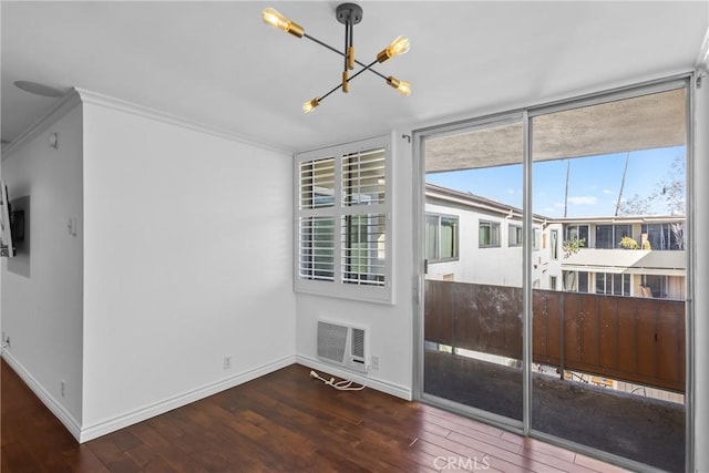 spare room with visible vents, baseboards, hardwood / wood-style flooring, and a notable chandelier