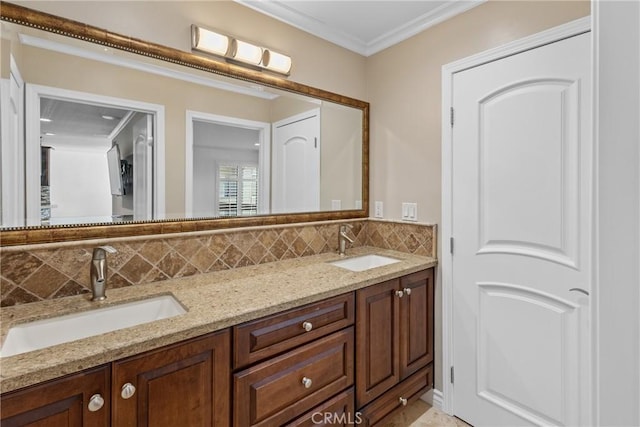 bathroom with double vanity, crown molding, backsplash, and a sink