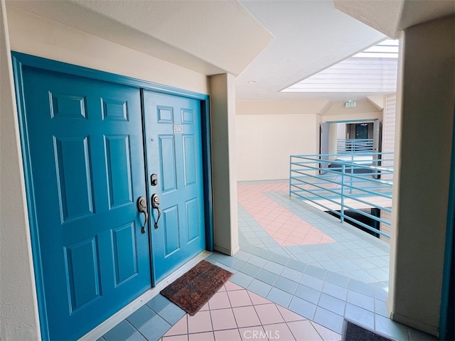 entrance to property featuring visible vents and a balcony