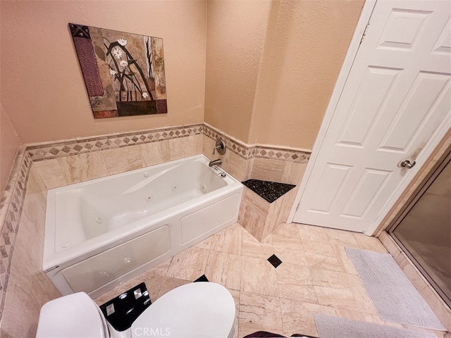 full bathroom with a shower stall, a jetted tub, and toilet