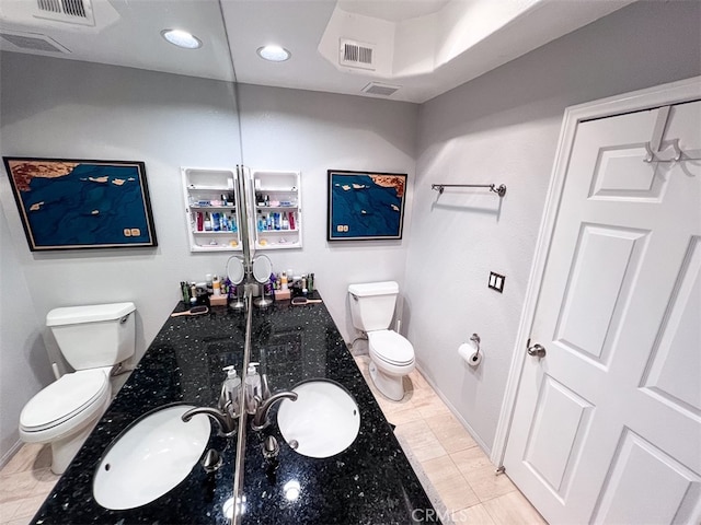 bathroom with visible vents, a sink, and toilet