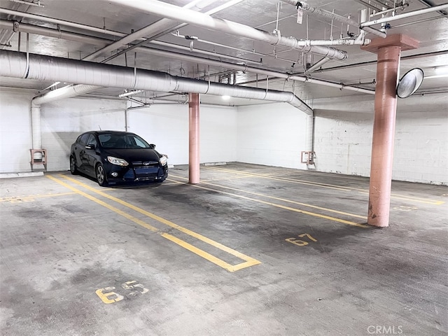 parking garage featuring concrete block wall