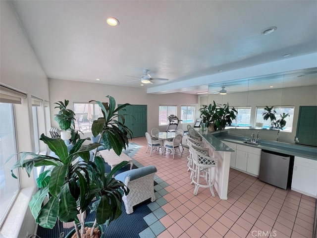 interior space featuring a sink and a ceiling fan