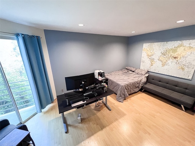 bedroom with recessed lighting, multiple windows, and wood finished floors