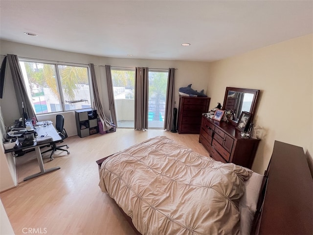 bedroom featuring access to outside and light wood-type flooring