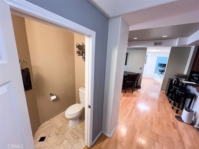 hall featuring recessed lighting, baseboards, visible vents, and light wood finished floors