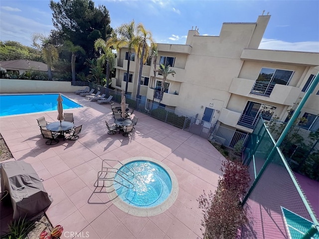 pool featuring a patio area and fence