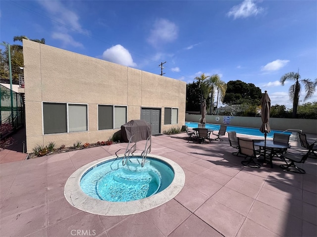 pool featuring a patio area and fence