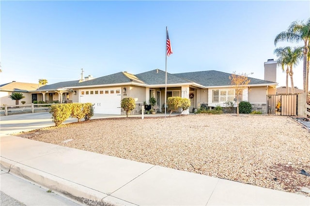 ranch-style home featuring a chimney, stucco siding, concrete driveway, an attached garage, and fence