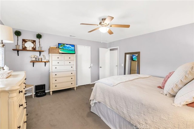 bedroom featuring light colored carpet, ceiling fan, and baseboards