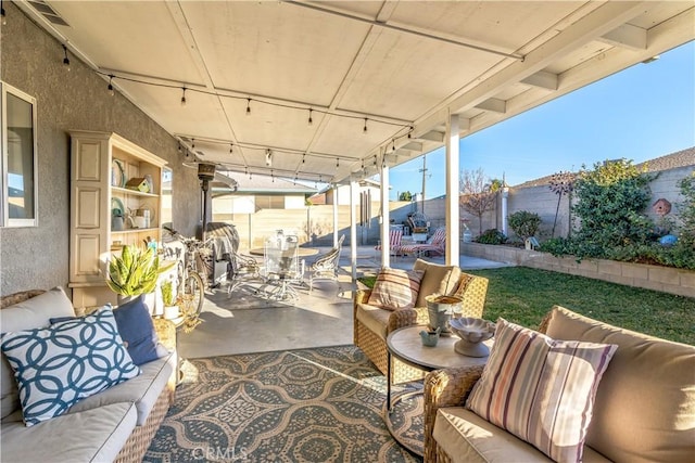 view of patio / terrace featuring a fenced backyard, an outdoor living space, and outdoor dining space