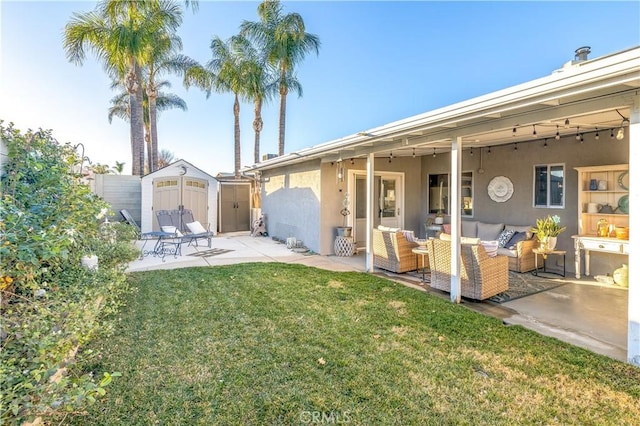 back of property with a storage shed, a patio, an outdoor structure, outdoor lounge area, and stucco siding