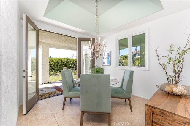 dining space with light tile patterned flooring and an inviting chandelier