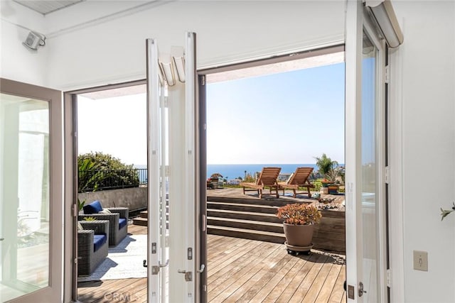 doorway featuring a water view and wood finished floors