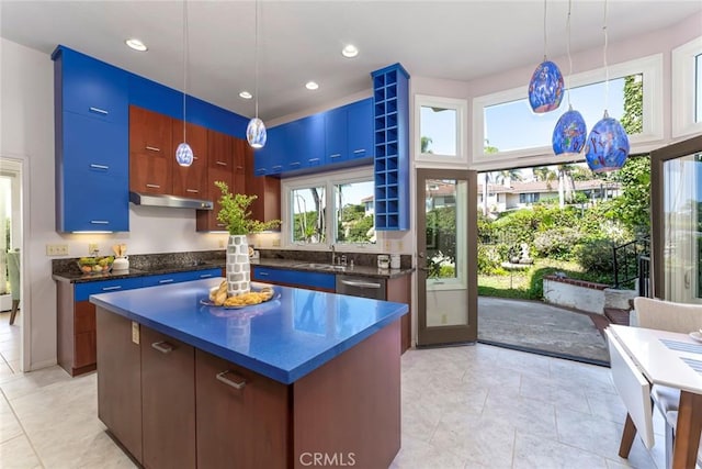 561 Avenida Del Verdor, San Clemente, CA 92672 - kitchen with dark countertops, under cabinet range hood, a kitchen island, light tile patterned floors, and recessed lighting