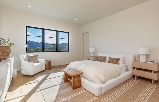 bedroom with wood finished floors and recessed lighting