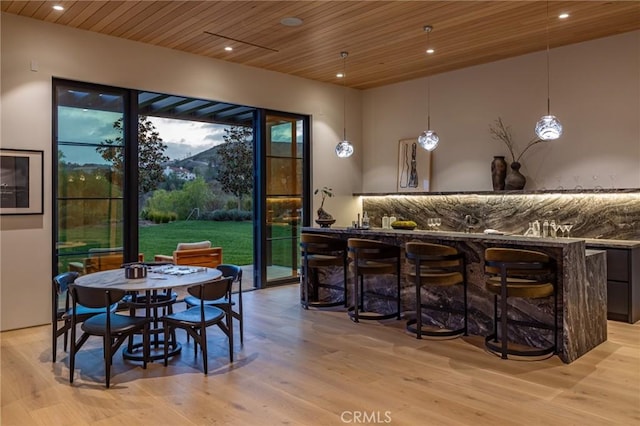 bar with recessed lighting, wooden ceiling, indoor wet bar, and light wood-style flooring