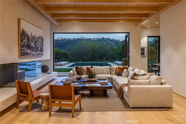 interior space with wooden ceiling, beam ceiling, and wood finished floors