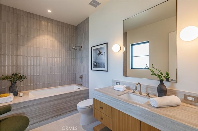 bathroom featuring tile patterned flooring, bathtub / shower combination, toilet, visible vents, and vanity