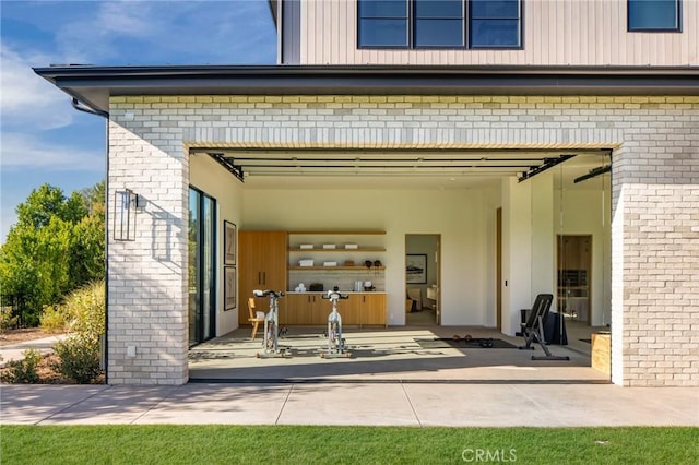 view of exterior entry featuring brick siding