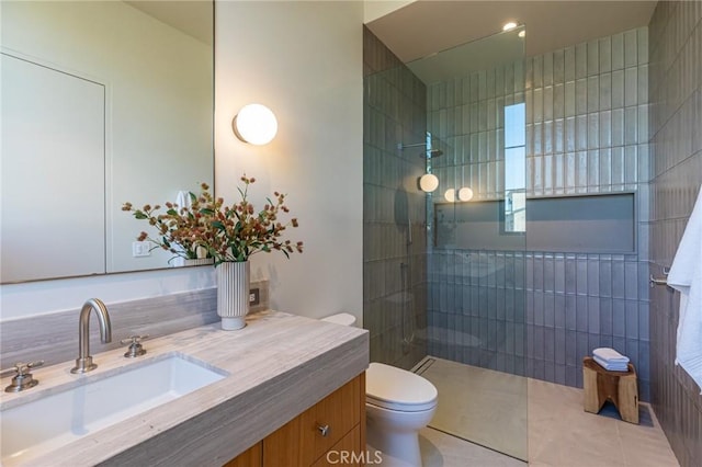 bathroom with a walk in shower, vanity, toilet, and tile patterned floors