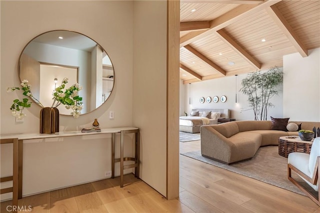 interior space featuring lofted ceiling with beams, light wood finished floors, wood ceiling, and recessed lighting