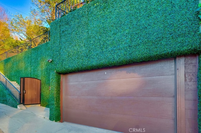 garage featuring a gate and fence