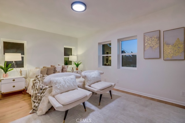 bedroom with light wood finished floors and baseboards