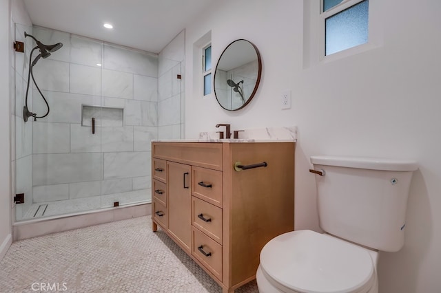 bathroom with a stall shower, vanity, toilet, and recessed lighting