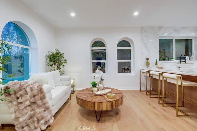 living area featuring light wood-style flooring and recessed lighting