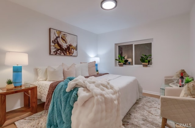 bedroom featuring baseboards