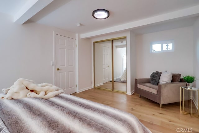 bedroom with light wood-style flooring and baseboards