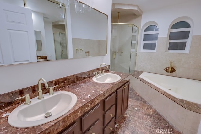 bathroom featuring double vanity, a stall shower, a sink, and a bath