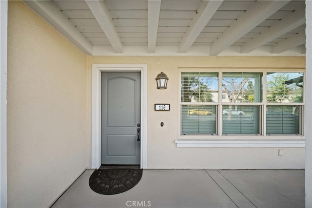 view of exterior entry with stucco siding