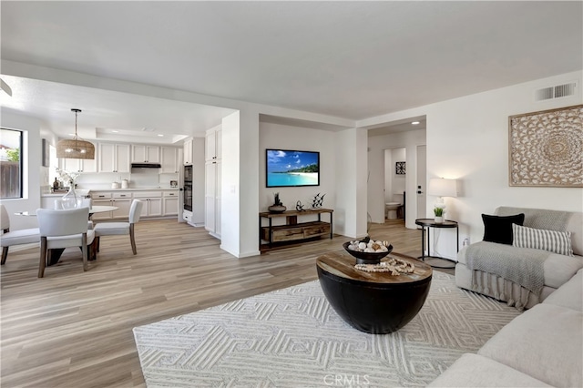 living room featuring visible vents, recessed lighting, and light wood-style floors