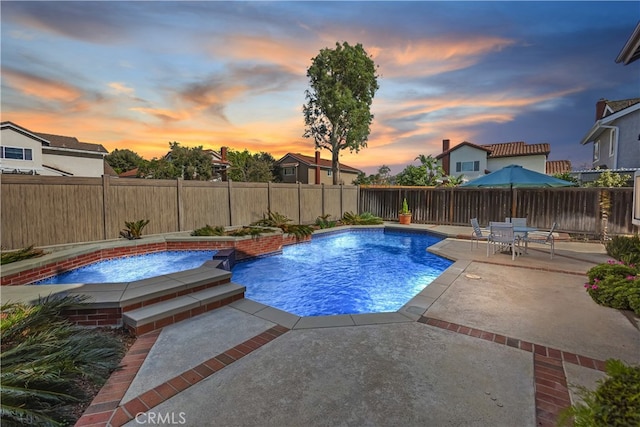 view of swimming pool featuring a patio, a fenced backyard, a fenced in pool, and an in ground hot tub