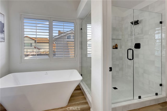 bathroom with a freestanding tub, plenty of natural light, and a shower stall