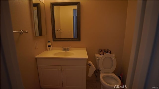 half bath featuring toilet and vanity