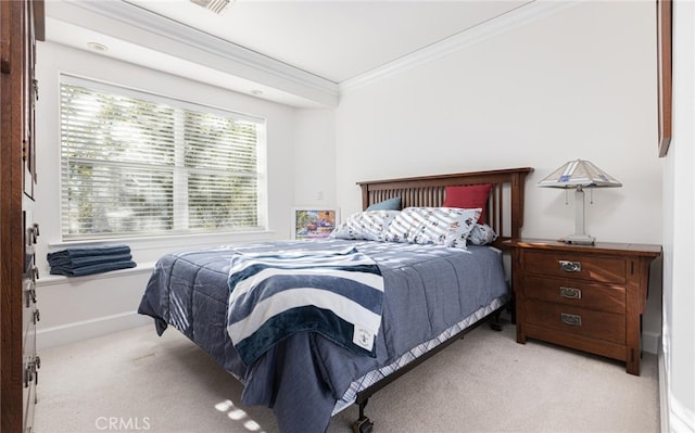 carpeted bedroom with baseboards and crown molding