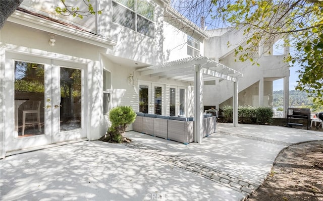 view of patio / terrace with french doors, an outdoor living space, and a pergola