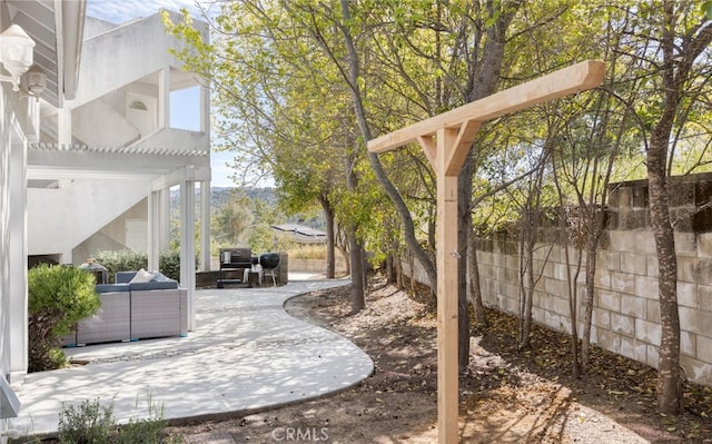 view of yard with fence, a pergola, and a patio