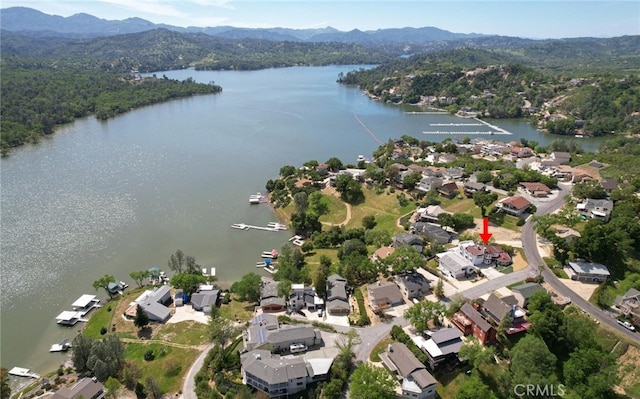 drone / aerial view with a residential view and a water and mountain view