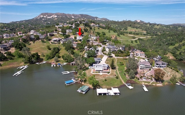 drone / aerial view featuring a water and mountain view